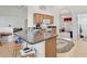 Bright kitchen with granite countertops, wooden cabinets, and an archway leading to the living area at 8377 Mambo Ave, North Port, FL 34291