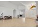 Open-concept area with tile flooring, neutral walls, and a glimpse of an office through an archway at 8377 Mambo Ave, North Port, FL 34291