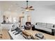 Open-concept living area showcasing tile flooring, neutral paint, and a view into the kitchen at 8377 Mambo Ave, North Port, FL 34291