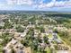 A scenic aerial shot displays a neighborhood with tree-lined streets and lush landscapes under a partly cloudy sky at 8377 Mambo Ave, North Port, FL 34291