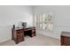 Bright office space with a wooden desk, ample natural light, and a comfortable chair at 8377 Mambo Ave, North Port, FL 34291