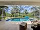 Refreshing pool and spa within a screened enclosure, perfect for enjoying outdoor relaxation and entertaining at 8377 Mambo Ave, North Port, FL 34291