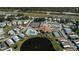 Aerial view of the community center, including a pool, tennis courts and a lovely pond feature at 857 Seabrooke Dr, Englewood, FL 34223