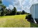 Spacious backyard with lush green grass and shade trees provides a tranquil retreat at 857 Seabrooke Dr, Englewood, FL 34223