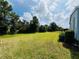 Expansive backyard with verdant lawn and trees offering space and natural beauty at 857 Seabrooke Dr, Englewood, FL 34223