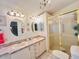 Bathroom boasting a double sink vanity, shower and nautical decor touches throughout at 857 Seabrooke Dr, Englewood, FL 34223