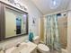 Bathroom with a vanity, framed mirror, and a shower/tub combination with a decorative shower curtain at 857 Seabrooke Dr, Englewood, FL 34223