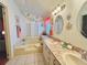 Inviting bathroom featuring double sinks, a tub, and a nautical-themed decor for a coastal vibe at 857 Seabrooke Dr, Englewood, FL 34223