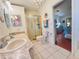 Bathroom with a double sink vanity, a glass-enclosed shower, and a view of the bedroom at 857 Seabrooke Dr, Englewood, FL 34223