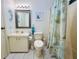 Clean bathroom featuring a coordinated vanity, toilet, and shower, with a seahorse decoration at 857 Seabrooke Dr, Englewood, FL 34223