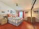 Comfortable bedroom with wood flooring, a vaulted ceiling, ceiling fan, and closet with full mirrored doors at 857 Seabrooke Dr, Englewood, FL 34223