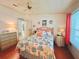 Cozy bedroom featuring a ceiling fan and a beach-themed comforter set and decorative wall art at 857 Seabrooke Dr, Englewood, FL 34223