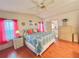 Bedroom with hardwood floors, a patterned comforter, and an ensuite bathroom at 857 Seabrooke Dr, Englewood, FL 34223