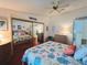 Relaxing bedroom featuring a ceiling fan, mirror closet, and coastal-inspired decor at 857 Seabrooke Dr, Englewood, FL 34223