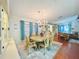 Cozy dining area featuring a chandelier, wooden table and chairs, and seamless flow to the living space at 857 Seabrooke Dr, Englewood, FL 34223