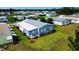 Charming blue home with a well-manicured lawn and landscaping in a tranquil neighborhood setting at 857 Seabrooke Dr, Englewood, FL 34223
