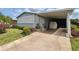 Inviting home exterior with covered parking, manicured landscaping, and a charming entrance at 857 Seabrooke Dr, Englewood, FL 34223
