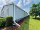 Well-maintained exterior with light blue siding, white trim and landscaped perimeter at 857 Seabrooke Dr, Englewood, FL 34223