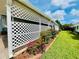 Landscaped yard with flowers and lattice accent, creating a charming curb appeal at 857 Seabrooke Dr, Englewood, FL 34223