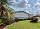 Charming home featuring manicured landscaping with lush greenery and colorful flowers, offering curb appeal at 857 Seabrooke Dr, Englewood, FL 34223