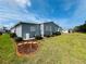 Charming home exterior with blue siding, manicured lawn and landscaping at 857 Seabrooke Dr, Englewood, FL 34223