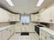 White kitchen cabinets, stainless sink, and modern appliances make this a cook's delight at 857 Seabrooke Dr, Englewood, FL 34223
