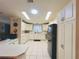Bright kitchen features white cabinets, modern appliances, and tile flooring for a clean, stylish look at 857 Seabrooke Dr, Englewood, FL 34223