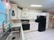 Featuring white kitchen cabinets and modern appliances, this kitchen offers a delightful cooking experience at 857 Seabrooke Dr, Englewood, FL 34223