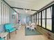 Enclosed lanai with a dining set, ceiling fan, tile flooring, and a calming blue color palette at 857 Seabrooke Dr, Englewood, FL 34223