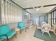 Relaxing sunroom features tile floors, ceiling fan, and cozy seating for year-round enjoyment at 857 Seabrooke Dr, Englewood, FL 34223