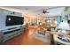 Spacious living room showcasing comfortable seating, entertainment center, and a view into the dining area at 857 Seabrooke Dr, Englewood, FL 34223