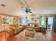 Comfortable living room with stylish seating, built-in shelving, and a view to the outdoor space at 857 Seabrooke Dr, Englewood, FL 34223