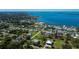Wide aerial view of a neighborhood showcasing a waterfront community with lush surroundings and nearby ocean access at 900 Stewart St, Englewood, FL 34223