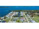 Aerial view shows canal-front homes in a charming waterfront community near the coast at 900 Stewart St, Englewood, FL 34223