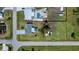 An aerial view of the property showcasing the home, pool, and expansive yard surrounded by neighborhood streets at 900 Stewart St, Englewood, FL 34223