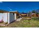 Backyard featuring a wooden deck with covering, a white fence, and well-manicured lawn at 900 Stewart St, Englewood, FL 34223