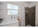 This bathroom features a tile shower with shower head, as well as a sink and mirror at 900 Stewart St, Englewood, FL 34223