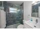 This updated bathroom features glass shower doors, decorative tile, and a modern sink at 900 Stewart St, Englewood, FL 34223