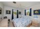 This bedroom features a queen bed, wood furniture, two windows, and a ceiling fan at 900 Stewart St, Englewood, FL 34223