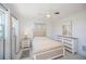 This bedroom features a queen bed, wood furniture, neutral decor, and lots of light at 900 Stewart St, Englewood, FL 34223