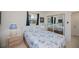 This bedroom has a queen bed, wood furniture, an updated ceiling fan, and lots of light at 900 Stewart St, Englewood, FL 34223