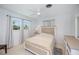 This bedroom has a queen bed, wood furniture, neutral decor, and a ceiling fan at 900 Stewart St, Englewood, FL 34223