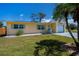 Inviting single-story home features well-maintained landscaping, complementing the home's bright exterior and charming details at 900 Stewart St, Englewood, FL 34223