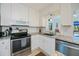 Bright kitchen features granite counters, stainless appliances, and ample cabinet space at 900 Stewart St, Englewood, FL 34223
