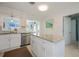 Charming kitchen with white cabinets, granite countertops, and stainless steel appliances, offering a functional layout at 900 Stewart St, Englewood, FL 34223