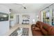 Inviting living room with a comfortable leather sofa and bright, airy feel, showcasing easy access to other rooms at 900 Stewart St, Englewood, FL 34223