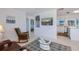 Open-concept living area flowing into the kitchen and bedroom hallway, featuring light walls and terrazzo floors at 900 Stewart St, Englewood, FL 34223