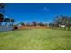 Large lot that is mostly grass with trees on the property and a wooden fence in the background at 900 Stewart St, Englewood, FL 34223