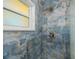 This shower features marble blue tile, a window for natural light, and modern hardware at 900 Stewart St, Englewood, FL 34223