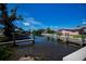 Waterfront canal featuring docks and a view of homes, reflecting blue skies and surrounding greenery at 900 Stewart St, Englewood, FL 34223